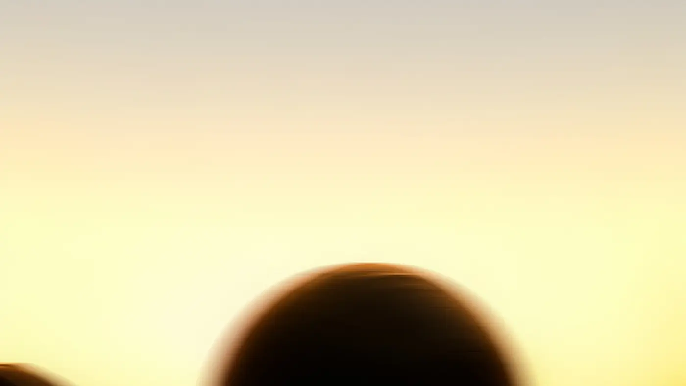 A member resting after a session, silhouetted against deep amber light