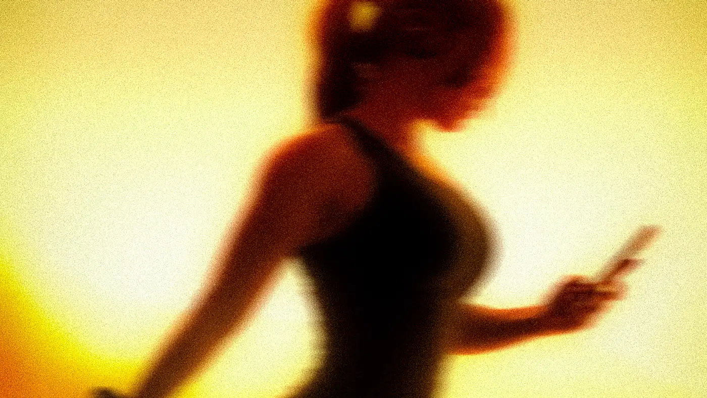 A member moving through a class, silhouetted against warm amber light